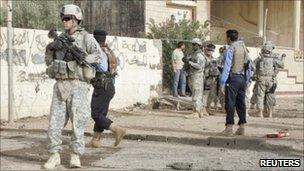 US soldiers and Iraqi policemen at the site of a bomb attack in Kirkuk, 250km (155 miles) north of Baghdad - 27 September 2010