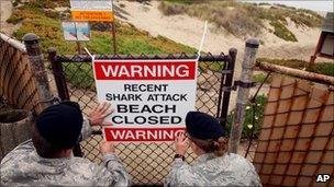 Officials post a warning sign on Surf Beach