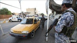 An Iraqi policeman stands guard at a checkpoint in Baghdad