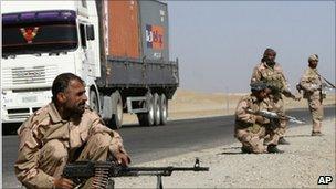 Private security contractors guard a road in the province of Ghazni, Afghanistan, 27 October 2010