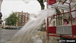 Burst pipe spews water on to a street near Lancaster Gate in London on 16 May 2006