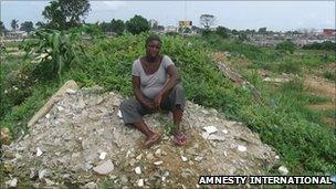 Former resident sits on the rubble that is her former home at Njemanze, in Port Harcourt