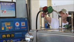 Driver filling up his truck with petrol at a Mobil filling station in Los Angeles