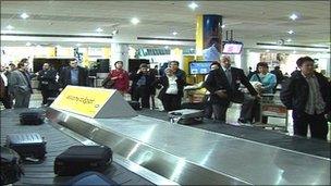 Passengers at Cairo airport luggage carousel