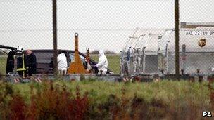 Police and firefighters check UPS cargo at East Midlands Airport