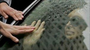 President Cristina Fernandez greets supporters as she accompanies her husband's hearse