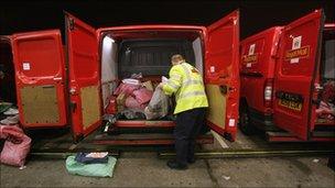 Royal Mail worker unloading bags of post at a sorting office in Bristol