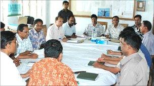 Grameen workers sitting round a table