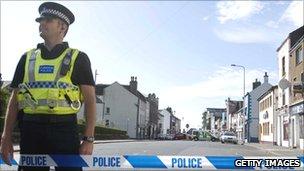 Policeman in sealed off street, Whitehaven, 2 June, 2010