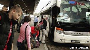 Polish workers boarding bus in Warsaw bound for London - file pic