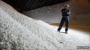 A Potash Corporation worker holding a handful of potash