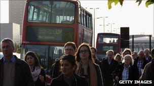 People walking beside buses