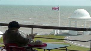 Pensioner on a balcony in Bexhill