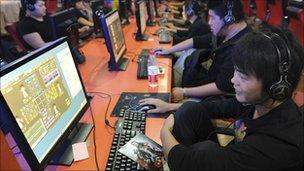 A teenager uses a computer at an internet cafe in Hefei, Anhui province, on 26 Sept 2010.