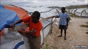 Quake survivors strengthen shelters as storm nears