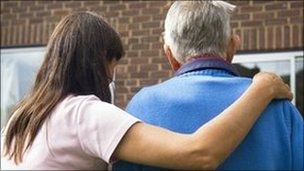 Woman helping elderly man