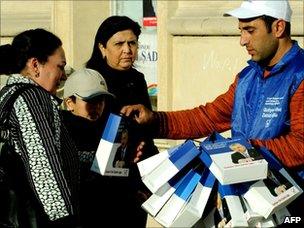 Party worker hands out election material in Baku