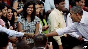 Barack Obama, right, shakes hands with students at St Xavier's College, Mumbai