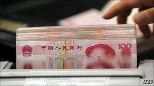 Clerk counting 100-yuan notes