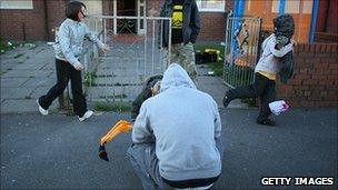 Family outside council estate in Salford