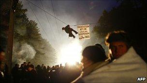 An anti-nuclear protester hangs on a rope as others block train tracks in a bid to delay the transport of nuclear waste in Gorleben, northern Germany