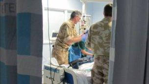 C-CAST team medics settle their patient in critical care at the QE after a flight from Kandahar.