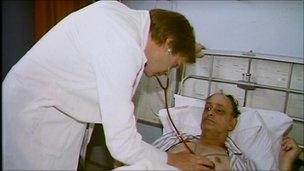 Doctor using stethoscope on patient