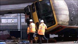 Railway workers at the scene of the crash