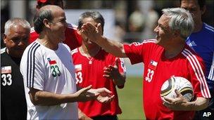 President Sebastian Pinera (right) jokes with freed miner Franklin Lobos after a football game on 25 October