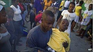 Man carries child with cholera symptoms in Port-au-Prince. 11 Nov 2010