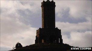 Darwen Tower with dome on ground next to it