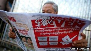 Man reads newspaper in Rangoon