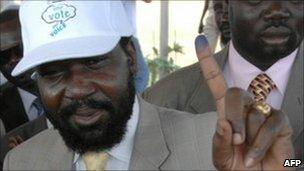 South Sudan President Salva Kiir showing his ink-stained finger after registering
