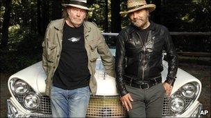 Neil Young, left, and record producer Daniel Lanois with the hybrid car