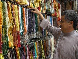 A man checks his wares at a stall in Mecca