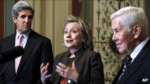 Hillary Clinton standing alongside John Kerry (left) and Richard Lugar