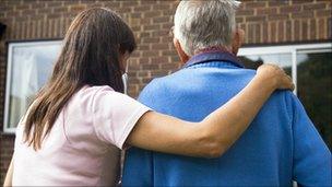 Elderly man being helped to his door