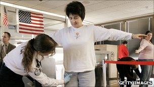 A traveller at a US airport being inspected