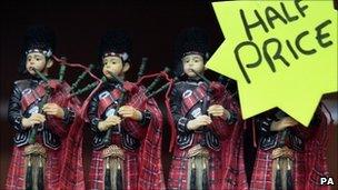 bagpipe figures with a half price sale sign