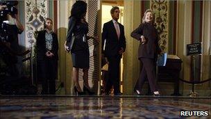 Hillary Clinton and John Kerry walking into a press conference