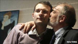 Blogger Adnan Hajizade (L) is kissed by his father, Hikmet, at his home in Baku (18 Nov 2010)