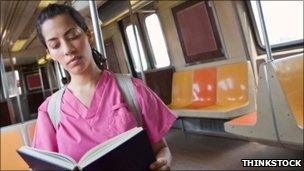 Nurse reading book on train