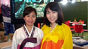 Two female members of the South Korea 2022 delegation in traditional costume