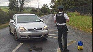 PSNI officer in front of car