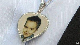 A picture of her son Mason Jones on a necklace worn by Sharon Mills