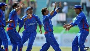 Afghan players celebrate the dismissal of Pakistani batsman Muhammad Azeem in the semi final