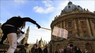 Student jumps over fence outside Oxford University's Radcliffe Camera building