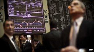 Brokers look at displays at the Stock Exchange in Madrid, 25 November