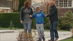 Mitchell with his parents after the operation