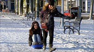 Two girls enjoy the snow in Edinburgh